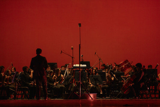 Band Director and Orchestra on Stage