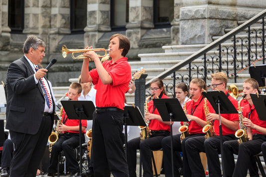 Band Director holding microphone for trumpet soloist