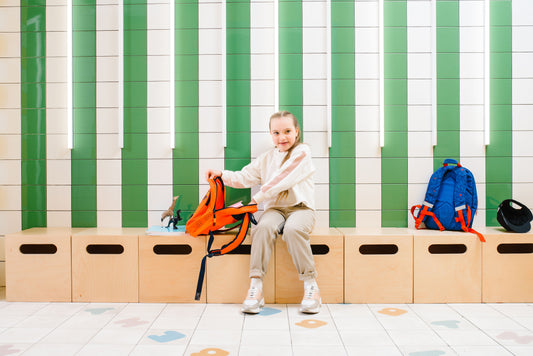Child sitting on organizing boxes