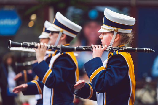 girls holding clarinets in marching band