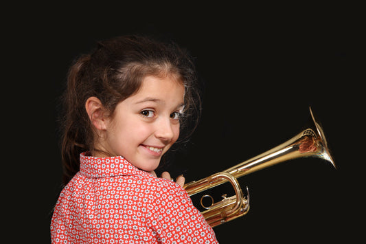 Girl smiling with a trumpet