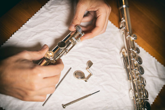 hands on a flute repair