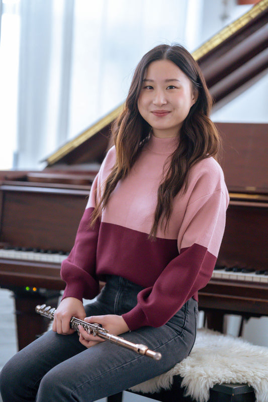 Teen Girl with flute in front of piano