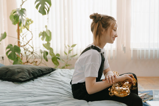Girl Sitting with Saxophone