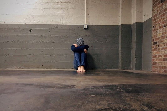 kid sitting alone in empty room