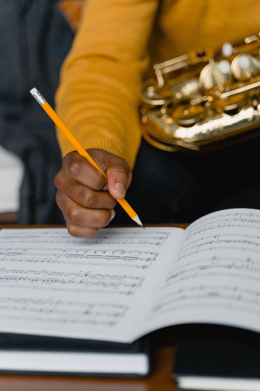 student with music and pencil and saxophone