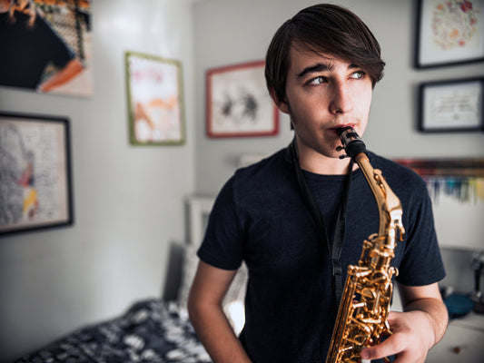 teen Boy playing saxophone alone