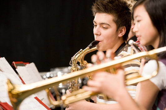 Boy and Girl playing sax and trumpet
