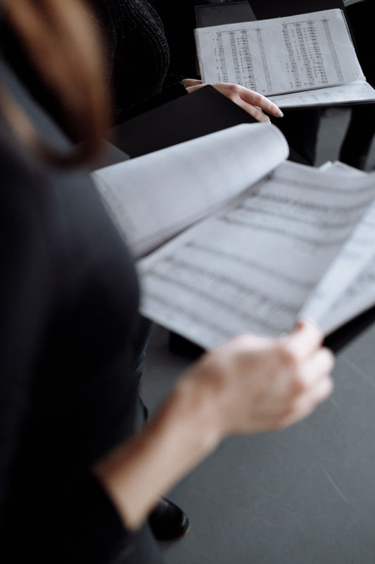 hands holding sheet music