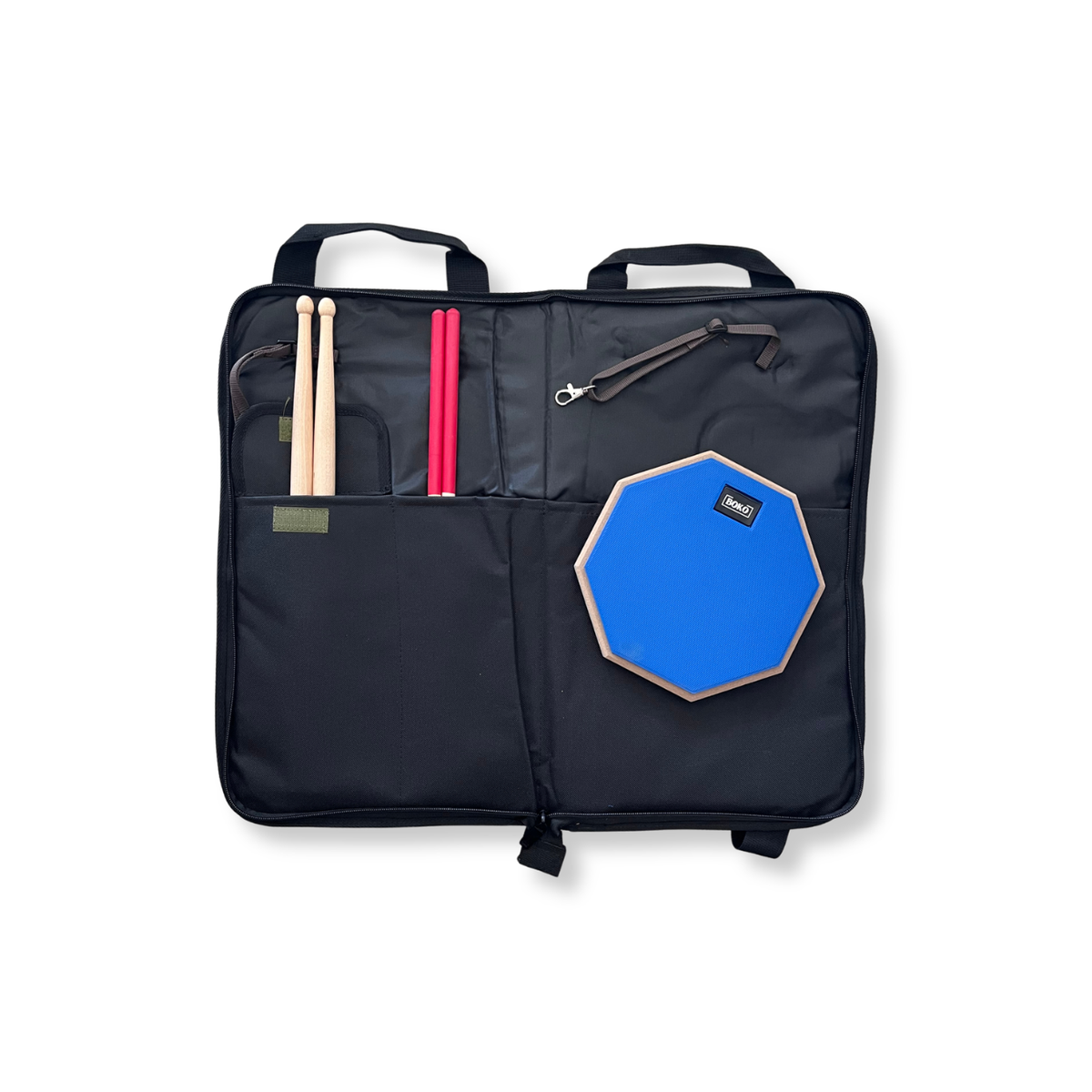 Black drumstick bag with a blue practice pad and drumsticks tucked inside