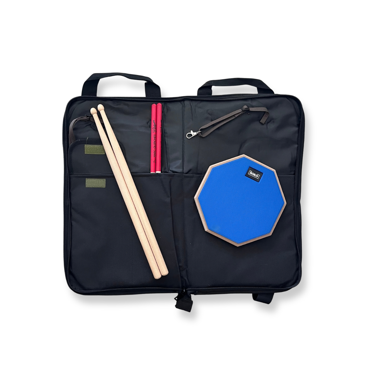 A black instrument bag laid open on a white background, containing a blue octagonal drum pad, two wooden drumsticks, and two pink drumsticks, with a small black logo patch on the drum pad.