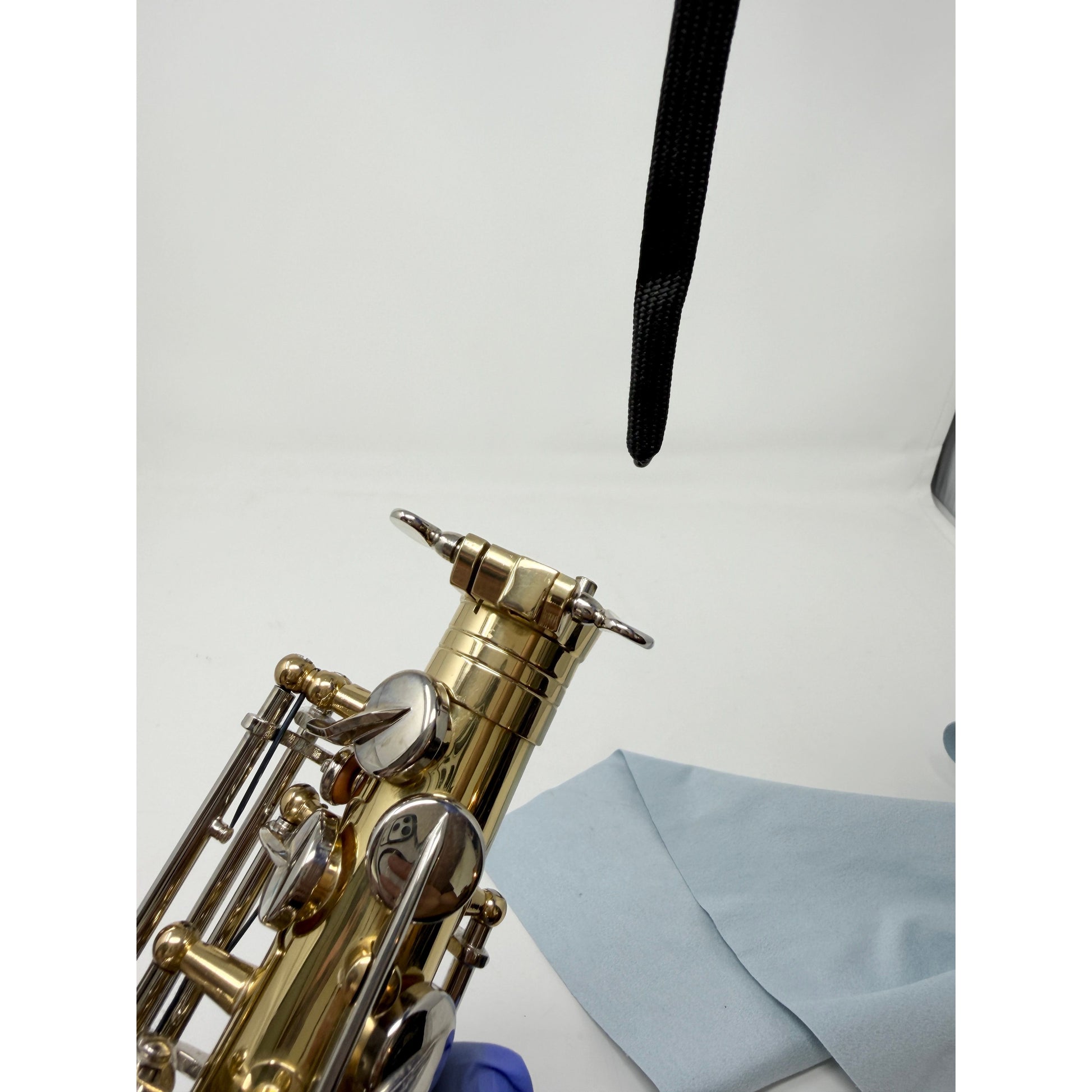 Weighted-end large saxophone swab before use