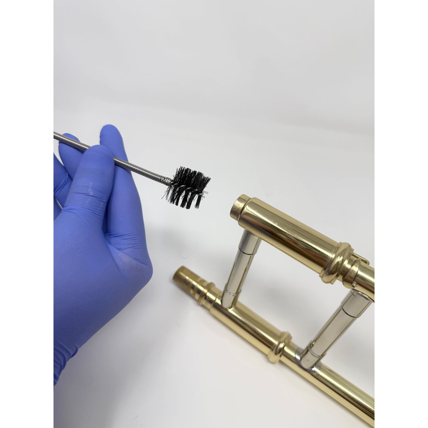 Snake brush for cleaning a trombone mouthpiece