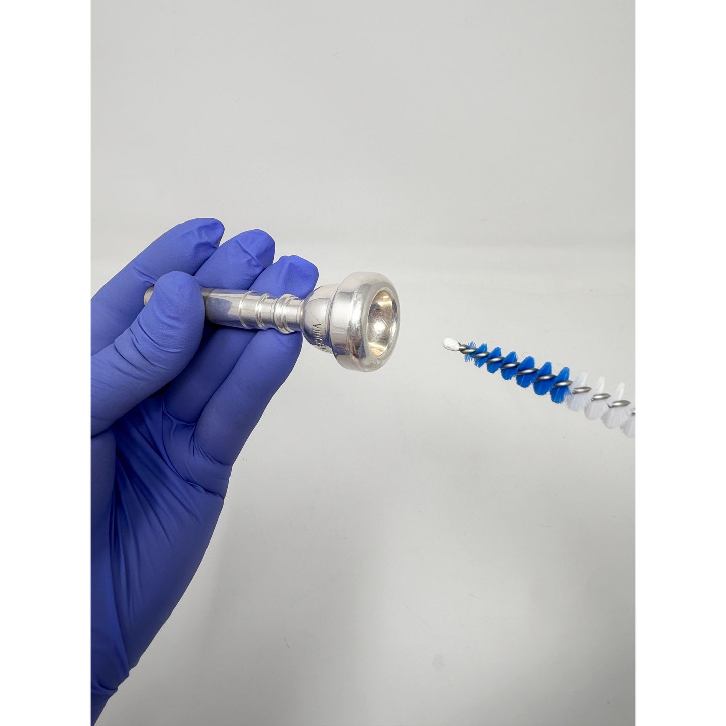 Conical brush for cleaning a trumpet mouthpiece